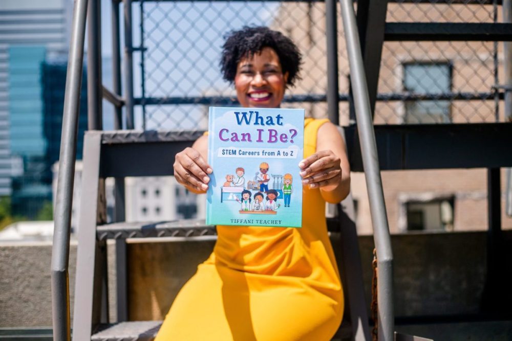 Tiffani Teachy holds children's book about STEM careers