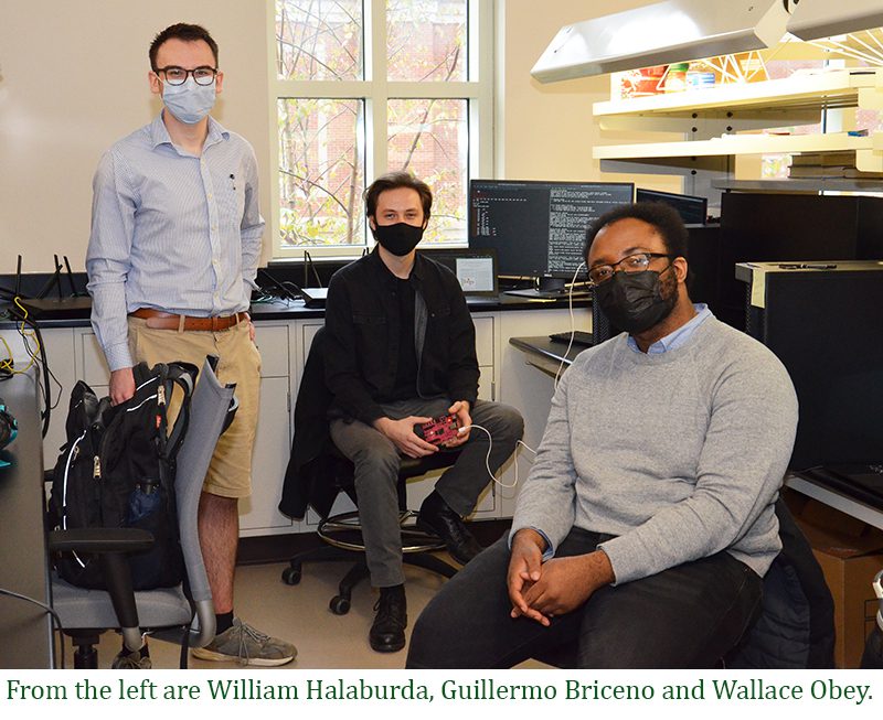 The three FLOW team members in a lab