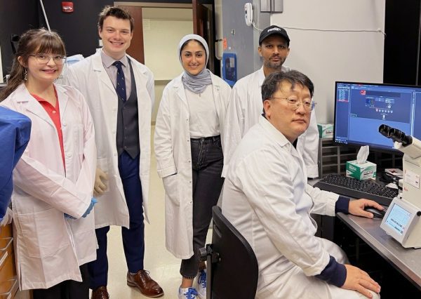 In Hong Yang pictured with students in his lab