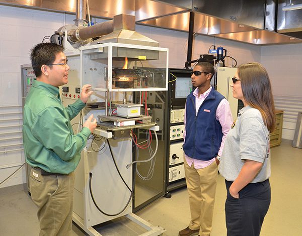 Professor and students in fire safety lab