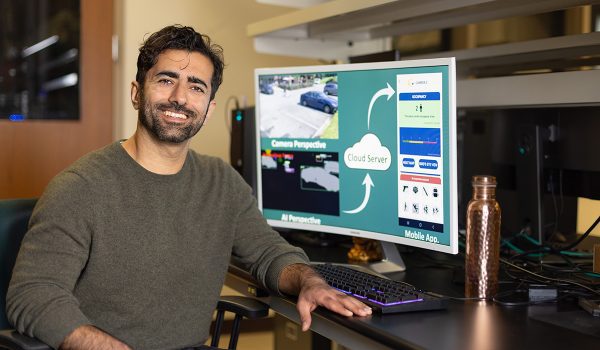 Photo shows Dr. Hamed Tabkhi at a computer