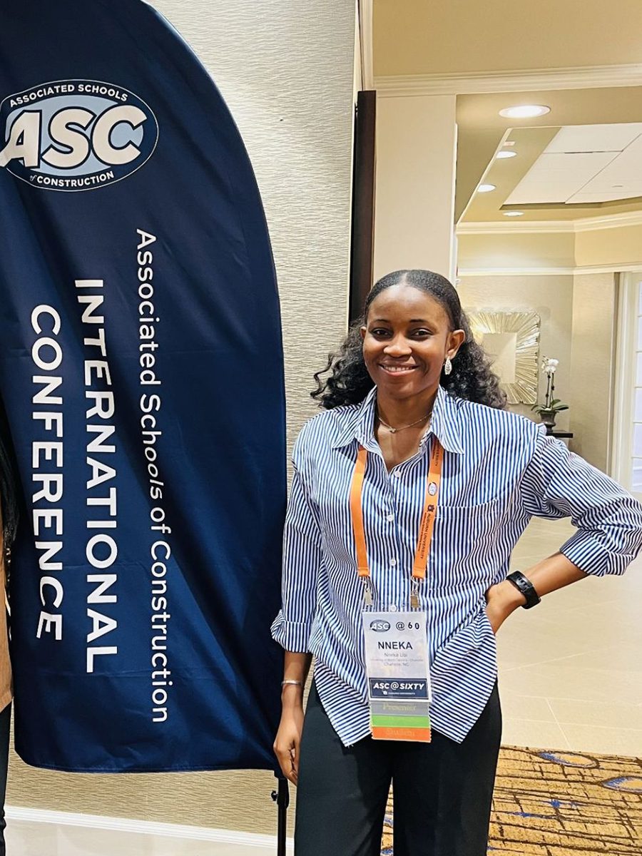Nneka Ubi standing in from of ASC conference sign