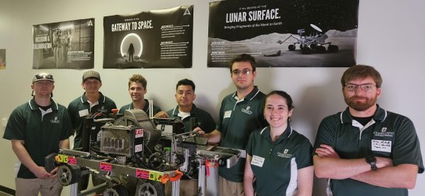49er Miners Team pose with robot at Kennedy Space Center