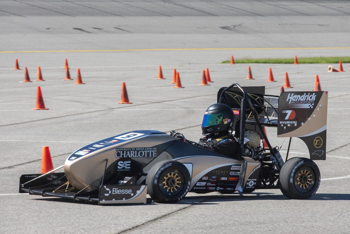 49ers Racing team member drives race car during competition