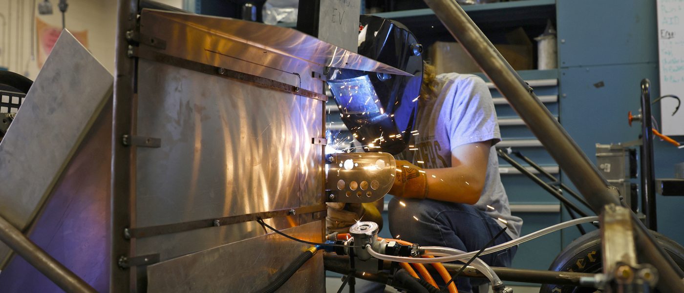 Student welding in the Kulwicki Motorsports Laboratory
