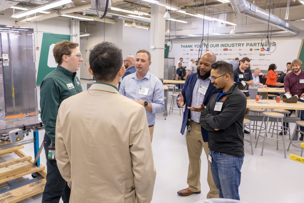 Guests connected with leadership from Lilly and UNC Charlotte while touring the Industrial Solutions Lab