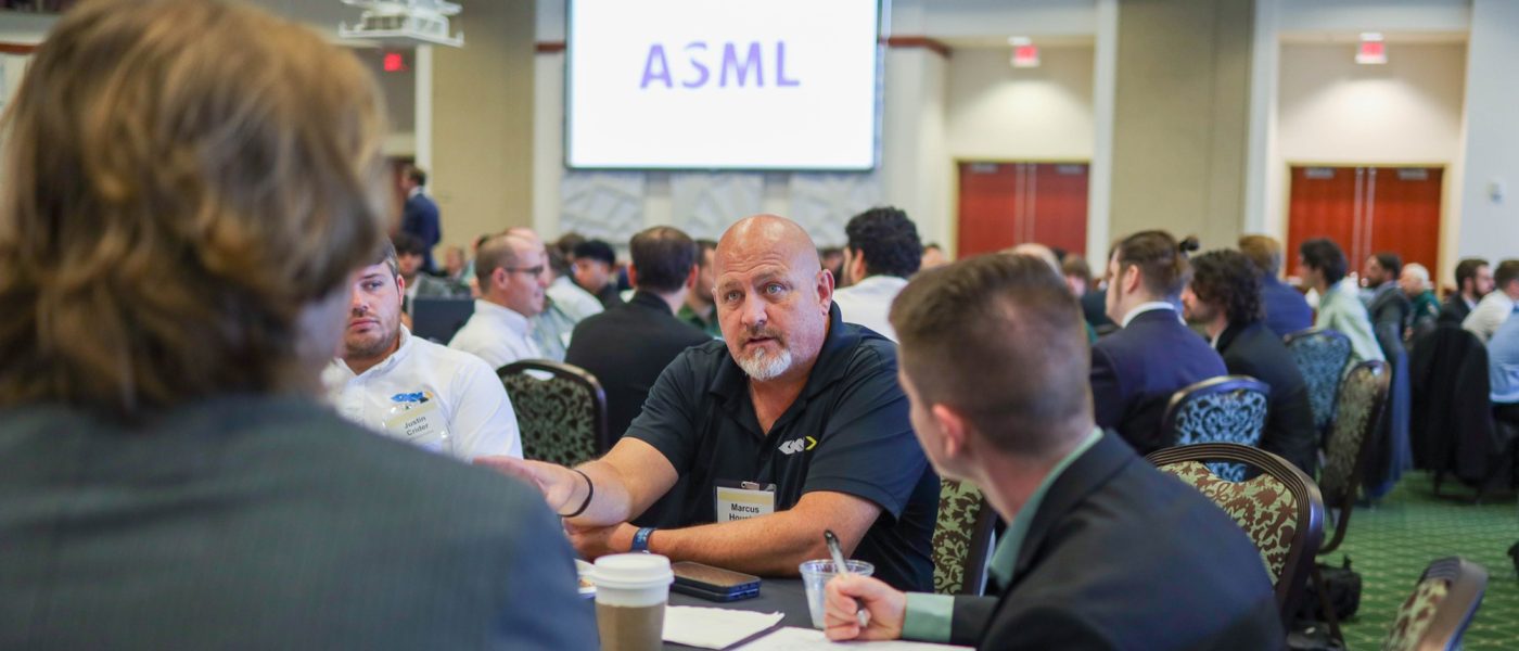 Seniors sit at table with industry partner during Senior Design Kickoff breakfast