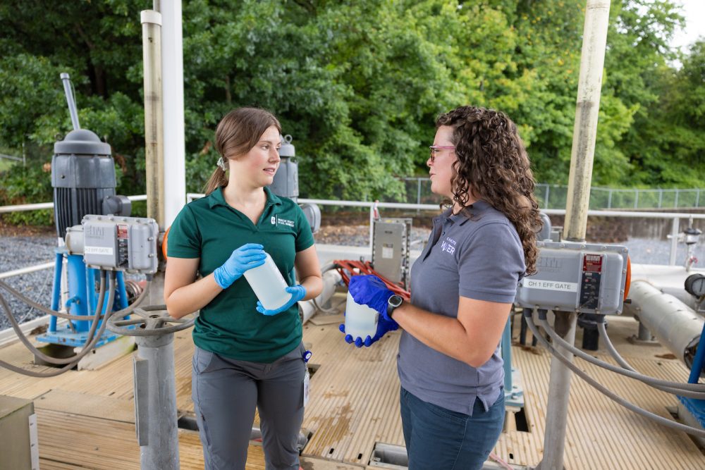 Two people collecting water samples