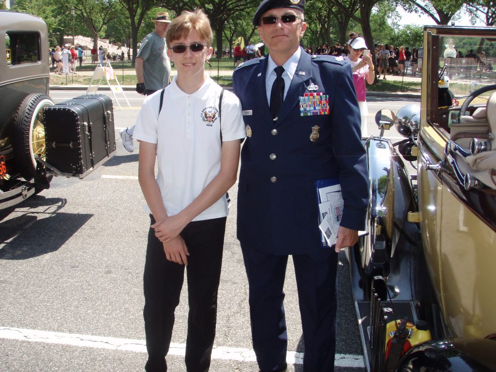 Scott Stewart Sr in military uniform standing beside his son