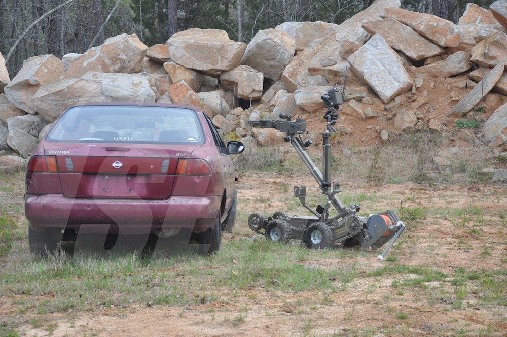 A robot moves near a parked car