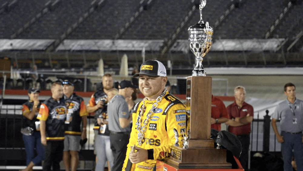 Layne Riggs standing with trophy