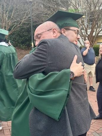 Scott Stewart Jr. embracing his father after graduating