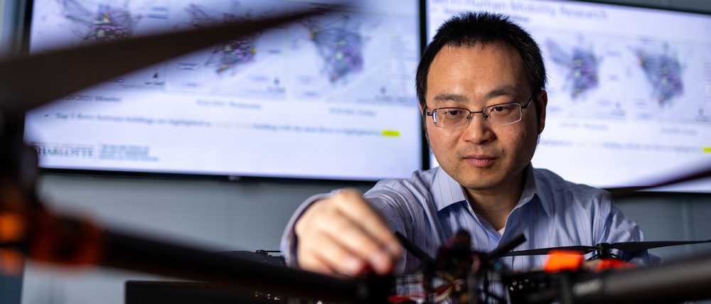 Lei Zhu works on a drone in a laboratory.