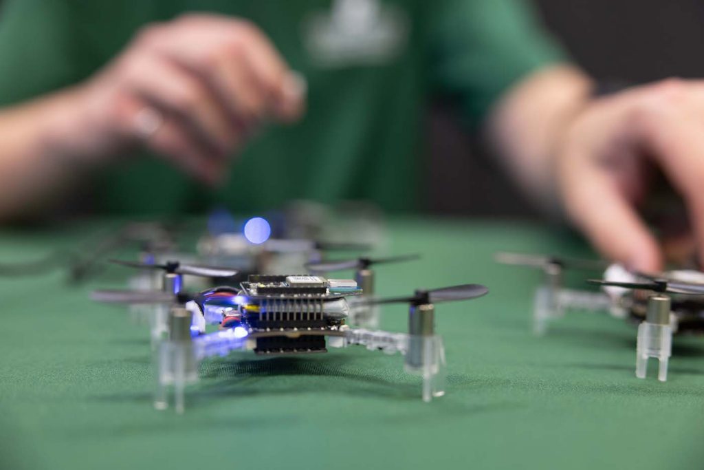 Group of drones on table with person in background