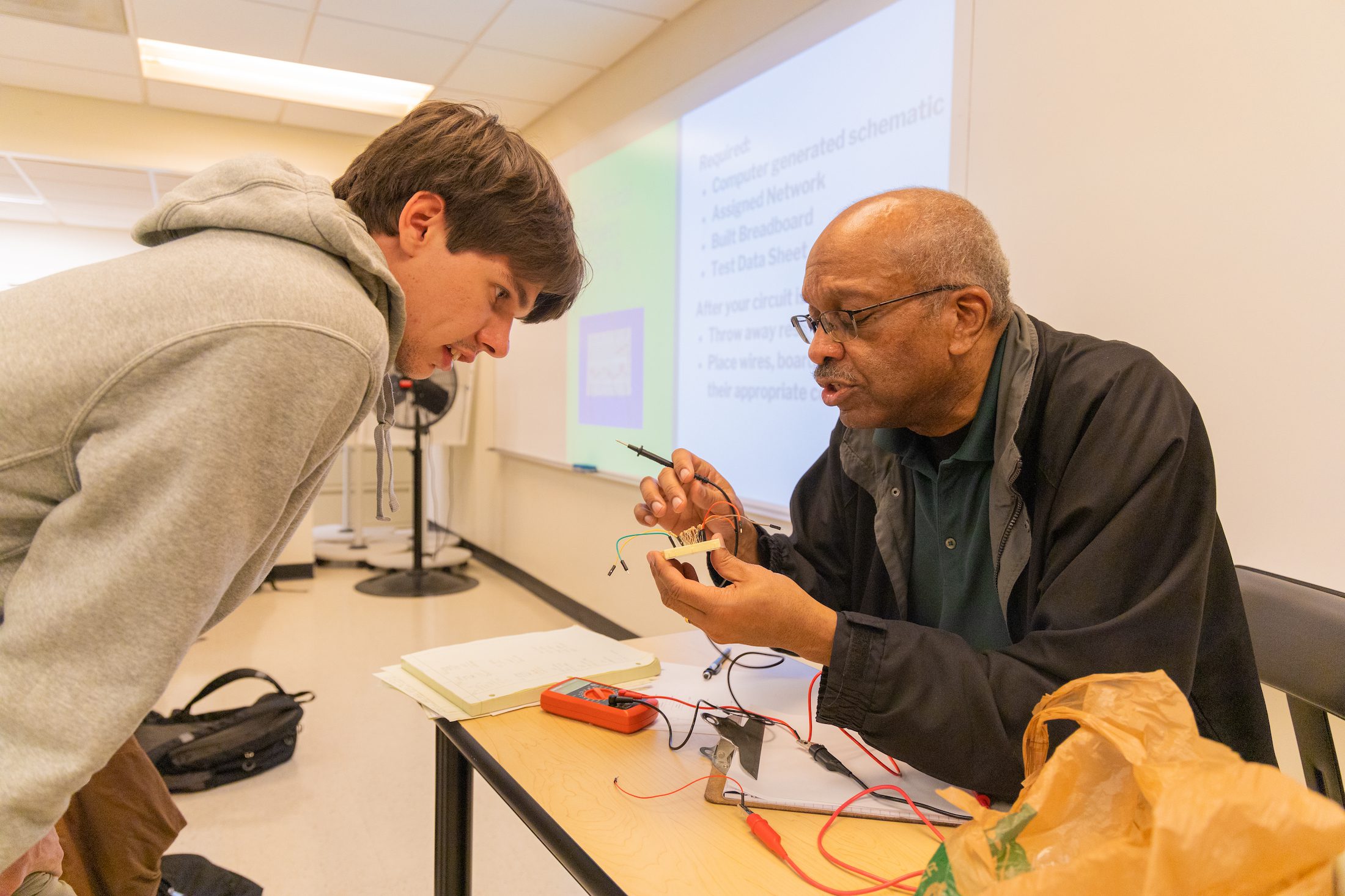 Student speaks with professor about circuitry