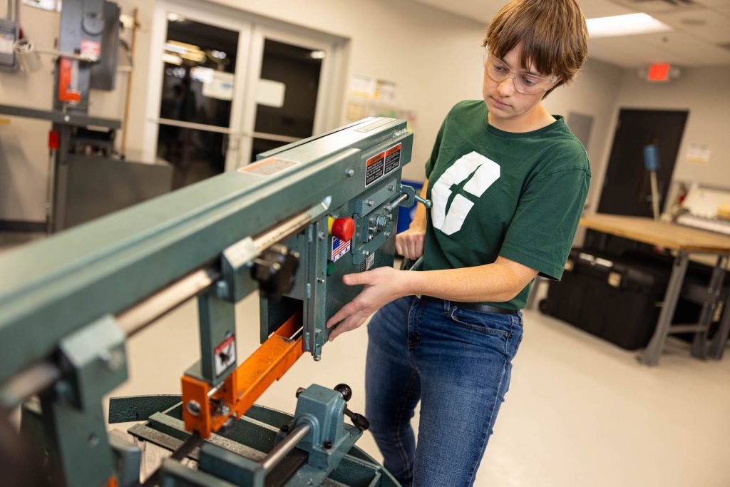 Student works on machine in the Industrial Solutions lab, powered by Lilly