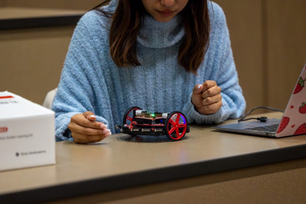 Student looking at robotic vehicle