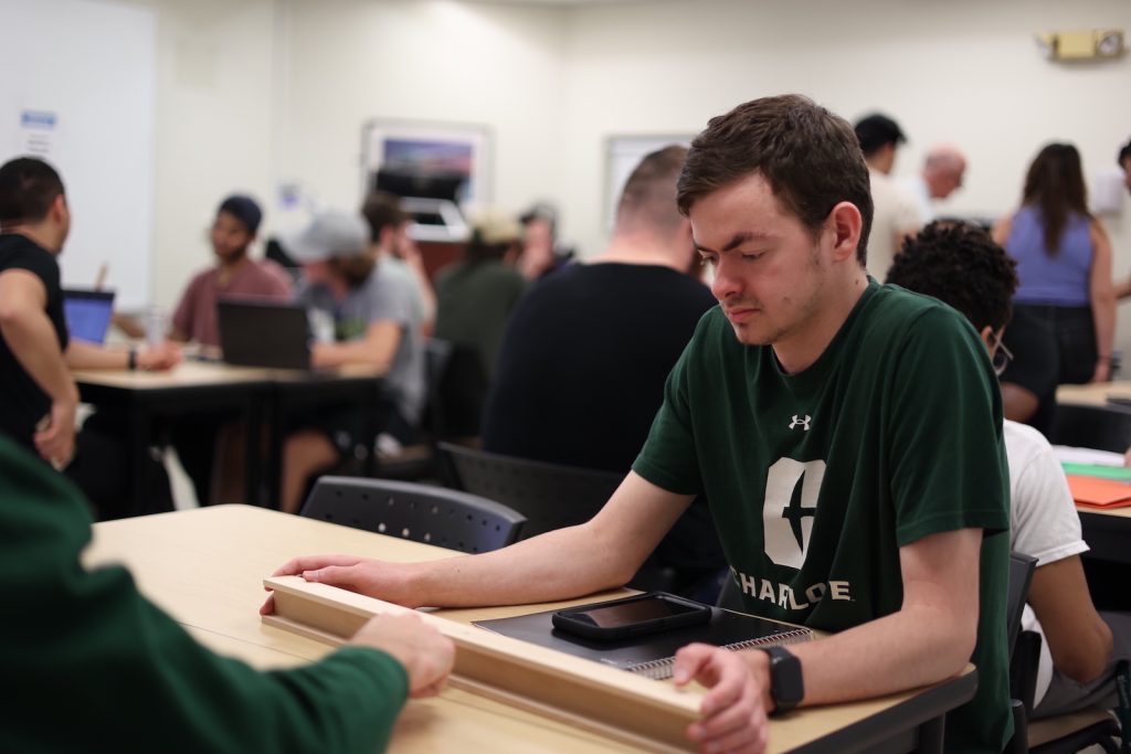 Student looking at a beam in class