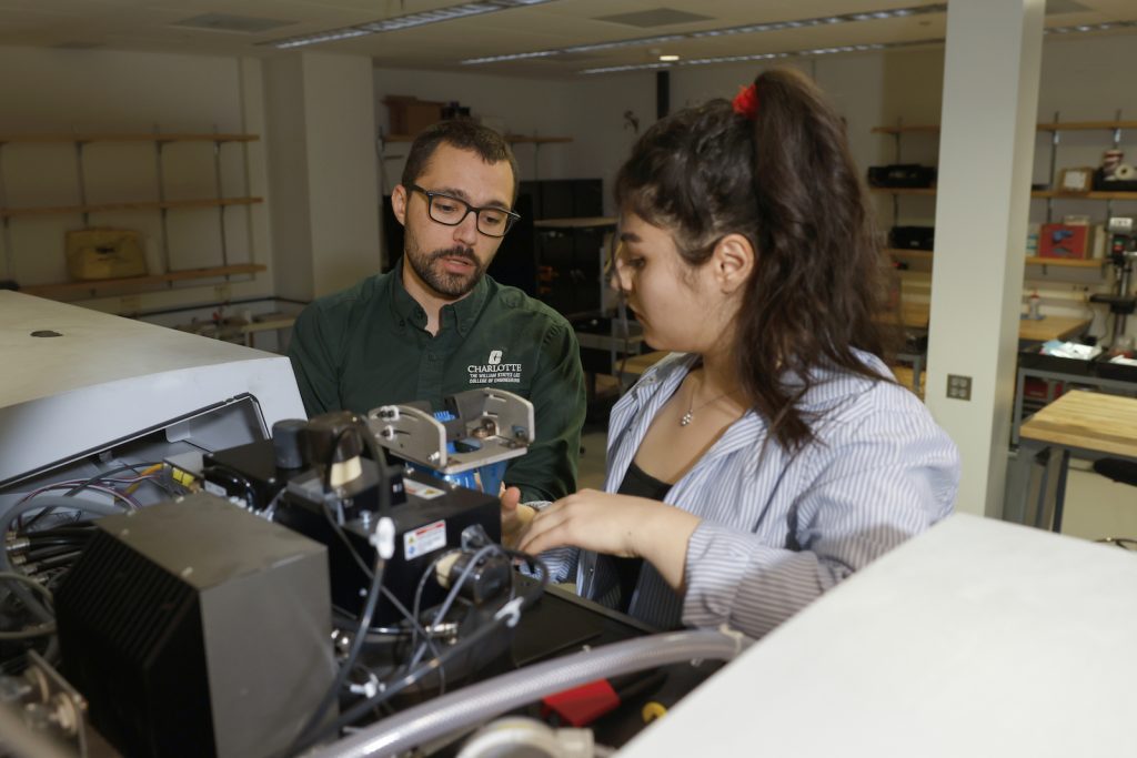 Professor and student work on Oerlikon AM additive manufacturing machine