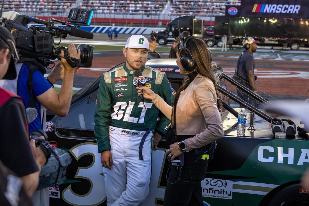 Layne Riggs speaks to reporter before NASCAR Truck Series race at Charlotte Motor Speedway