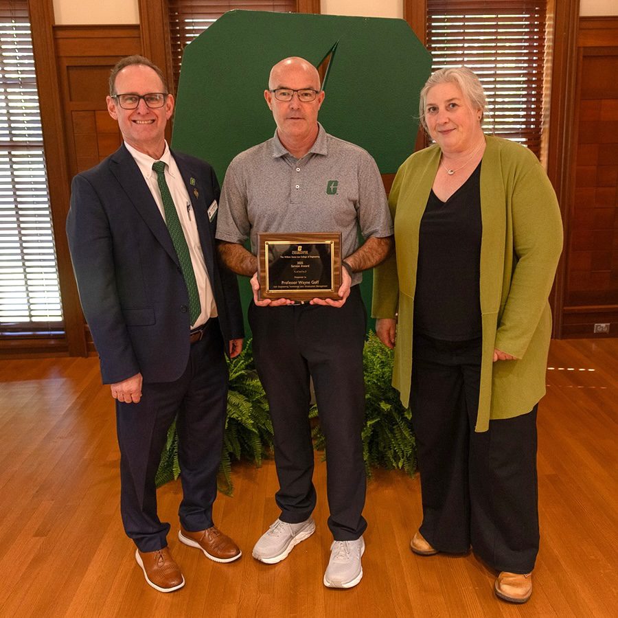 Dean Rob Keynton and Associate Dean for Research Brigid Mullany presenting award to Wayne Goff