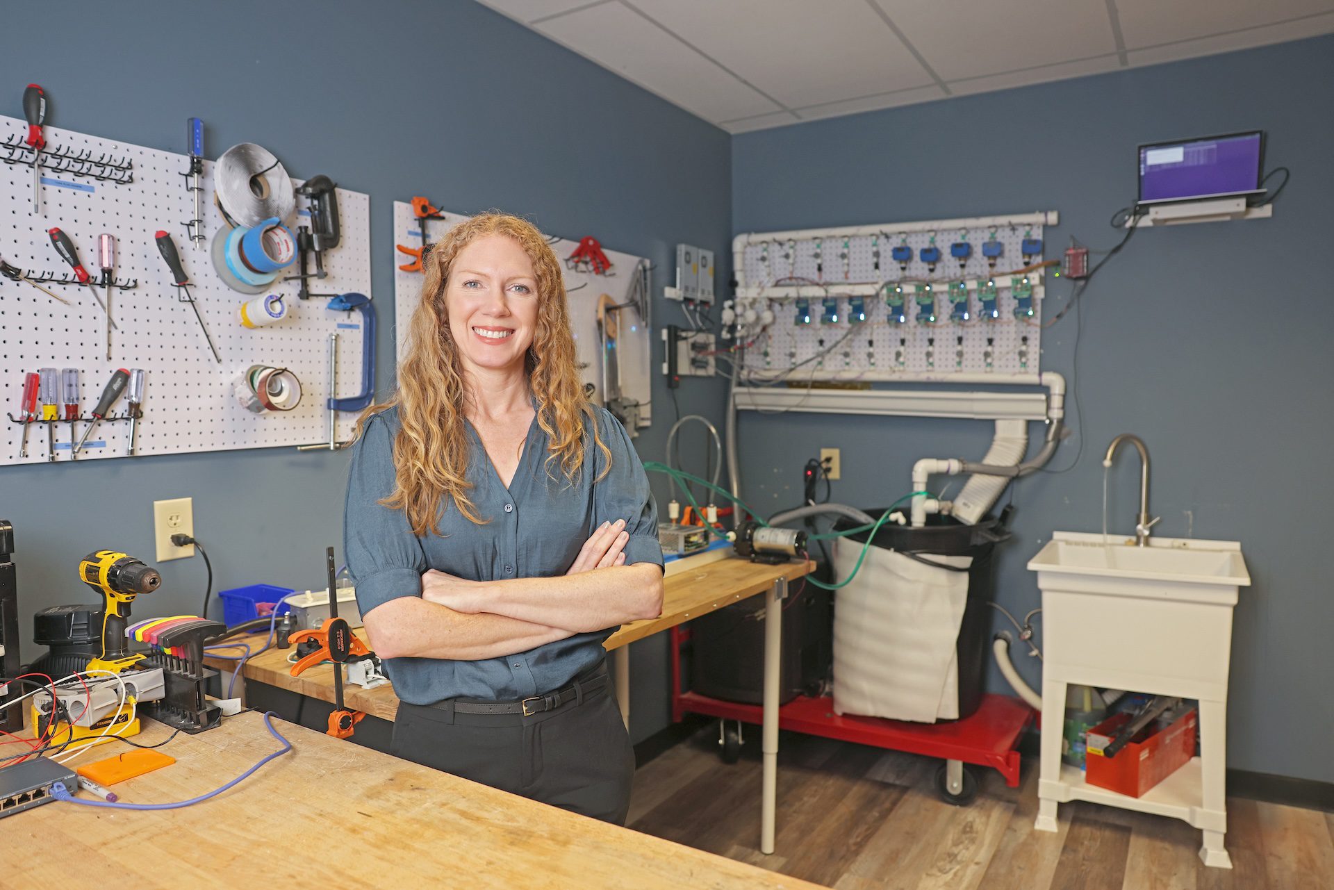 AquiSense founder Jennifer Pagan stands at a workstation