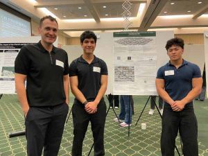 Professor Sabri Gokmen stands with students Andrei Vince and Aidan Oh
