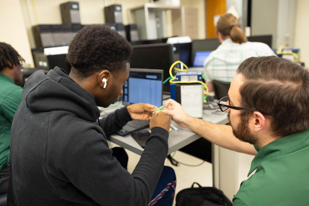 Instructor shows student how to use equipment