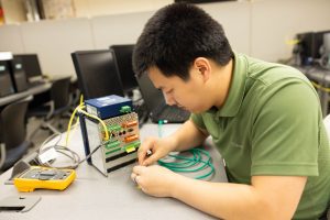 Student manipulating equipment with hands