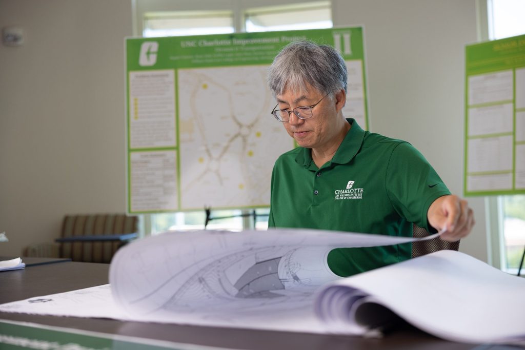 Charlotte professor Shen-En Chen looks at blueprints