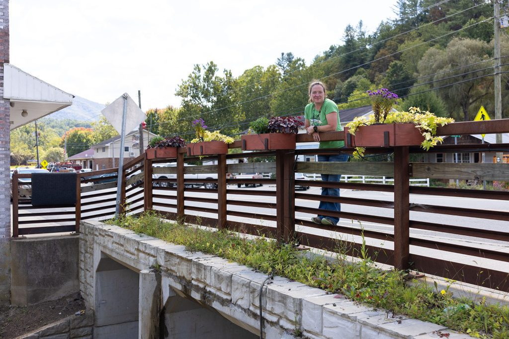 Charlotte alumna Emily Bridges stands on bridge railing
