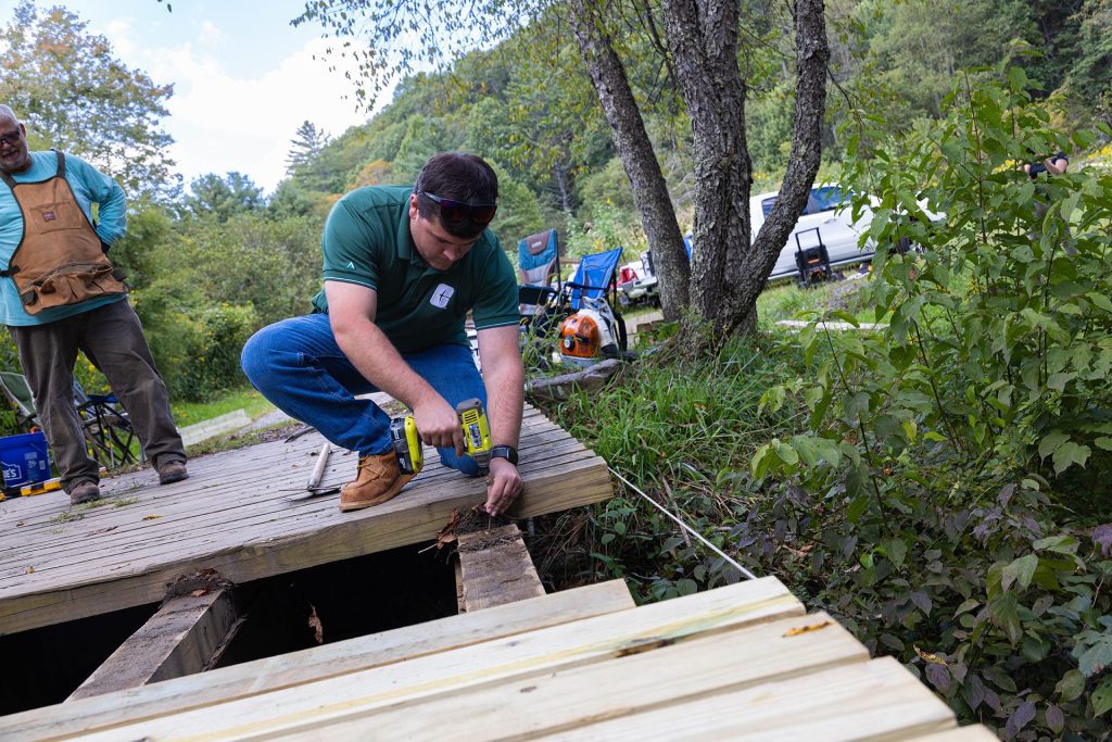Charlotte engineering student Nathan Hall repairs bridge
