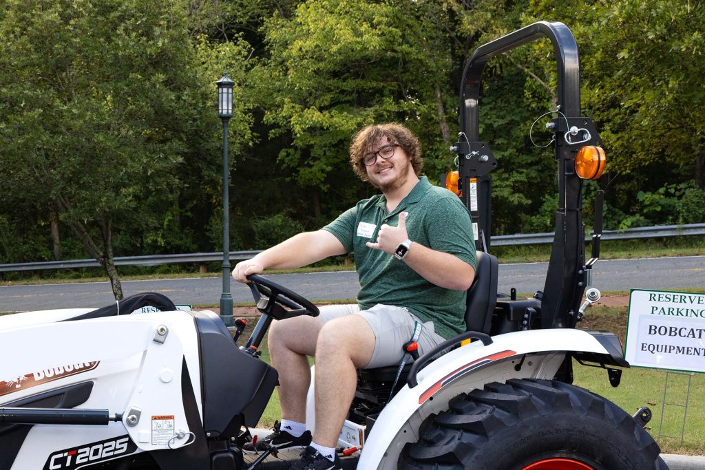 Braden Pomeroy, computer engineering major from Belmont, NC, tests Bobcat compact equipment after recognition event