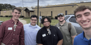 Five senior engineering students standing for group photo outside Bosch facility
