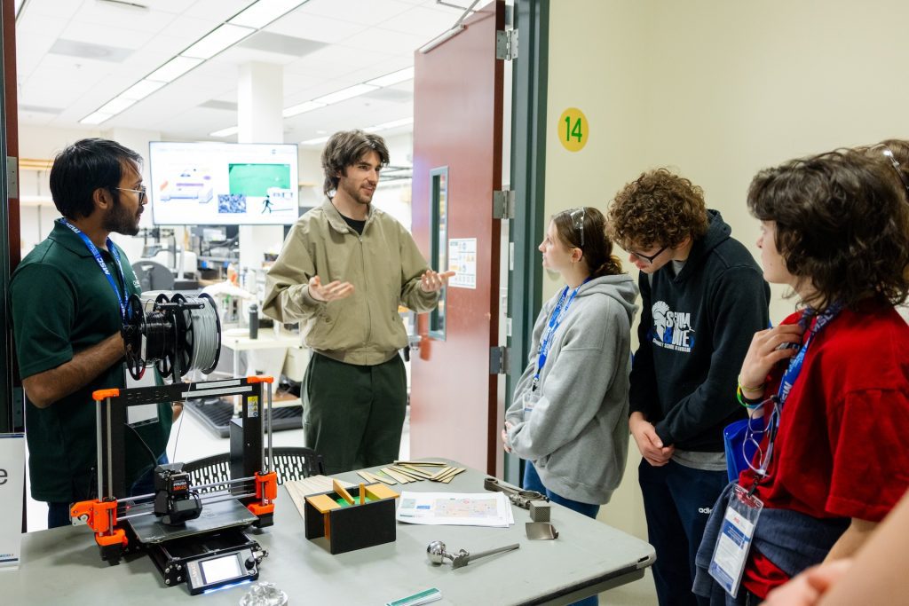 Niner Engineering students speak to high school seniors in a lab for Manufacturing Day
