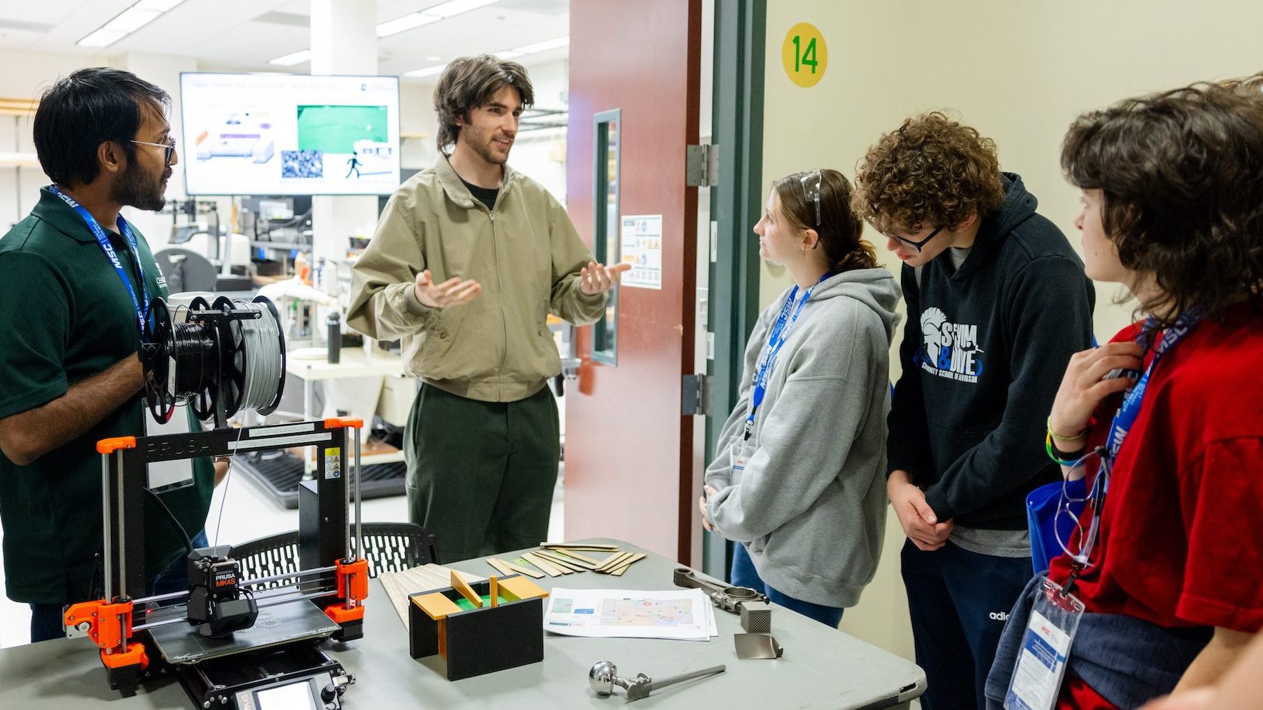 Niner Engineering students speak to high school seniors in a lab for Manufacturing Day