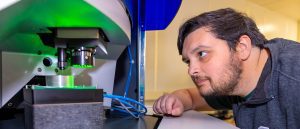 Graduate student looks closely at machine