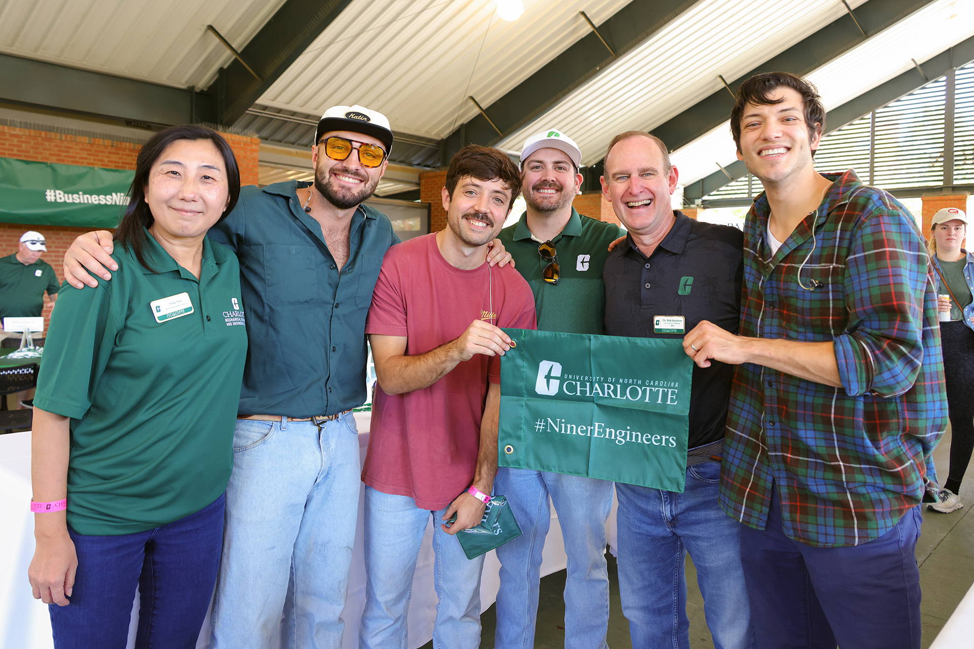 A group representing the William States Lee College of Engineering gathers at a Niner Nation Week tailgate
