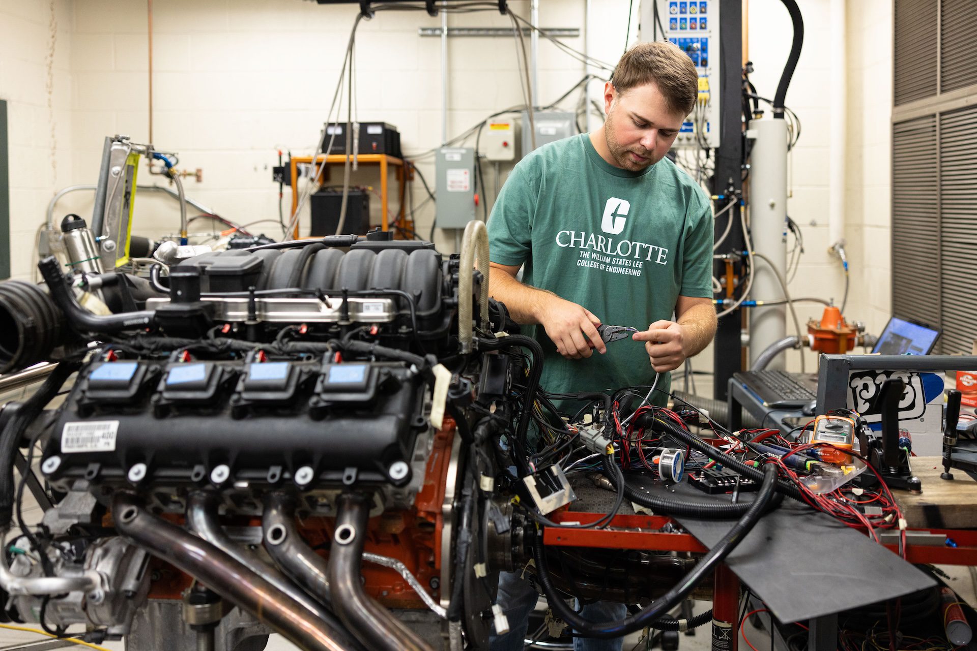 Layne Riggs works on a motor in the Kulwicki Motorsports Lab