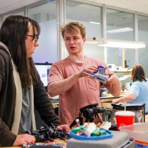 Two students talk in a lab