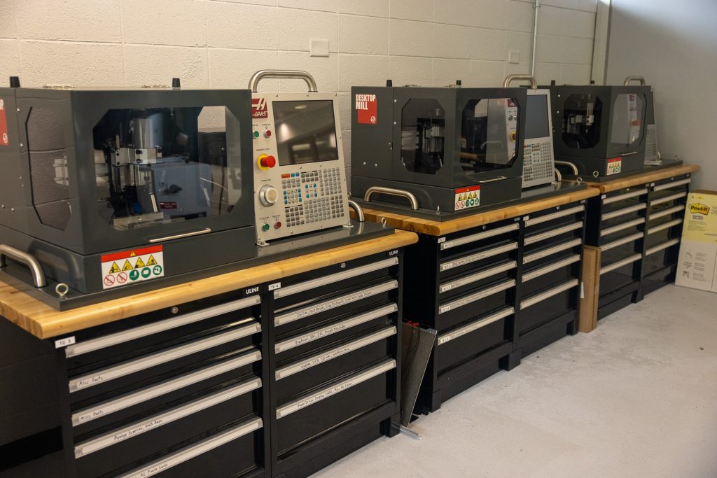 Row of three Haas desktop mills