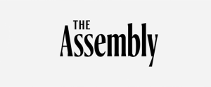 "The Assembly" written in black text
