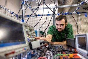 Student in lab surround by equipment